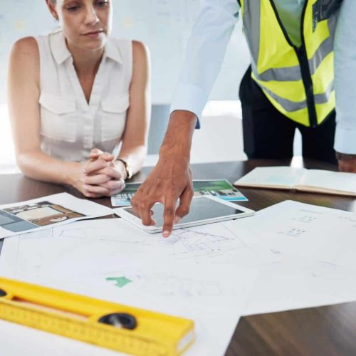 Construction, blueprint and planning with architect in meeting for consulting, project management a