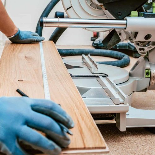 Preparing to Cut Wooden Plank for Flooring Installation