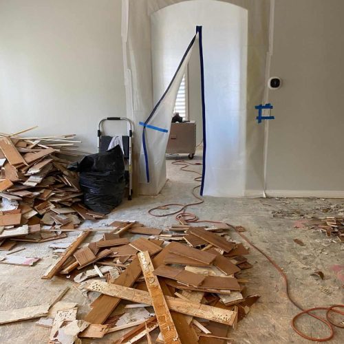 The flooring has been removed and the house is a mess in the middle of a remodel and demolition